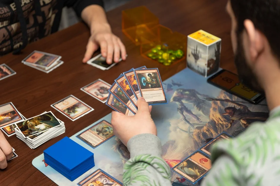 Magic the gathering cards and beer over a table